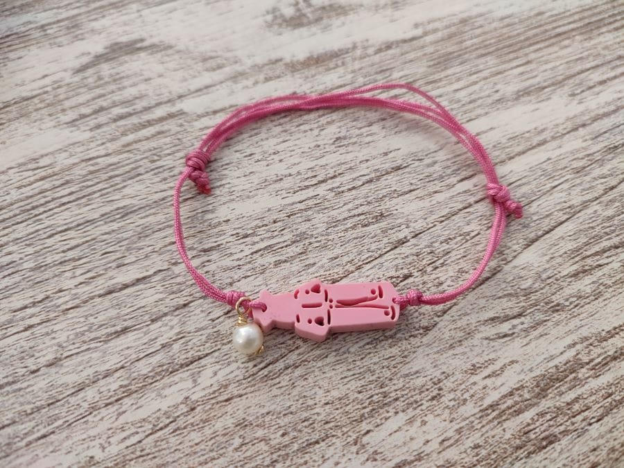 Pulsera rosa de San Roquede cordón y perla