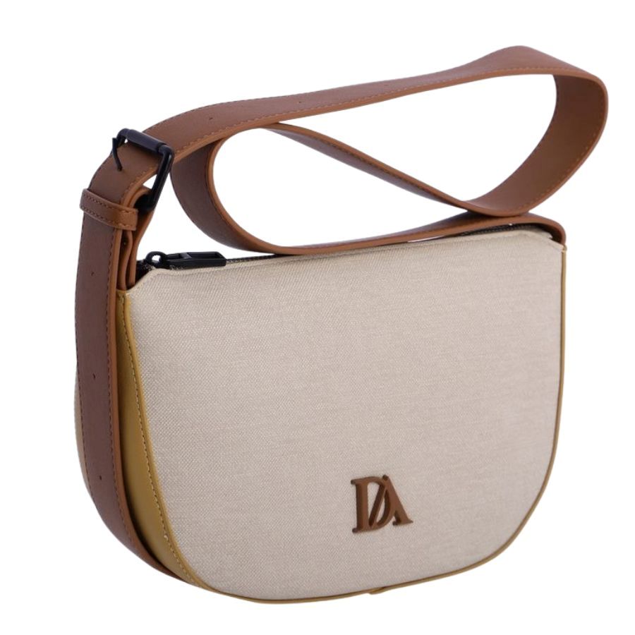 Bandolera mujer Don Algodon. Primer plano del logotipo DA de Don Algodon sobre tejido de lona beige de alta resistencia.
